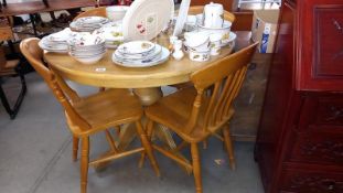 A solid light wood round-to-oval extending dining table and 4 chairs D105cm H79cm, COLLECT ONLY