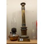A Victorian brass oil lamp column, cut glass drop in font & 2 chimneys