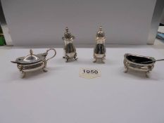 A four piece silver condiment set.