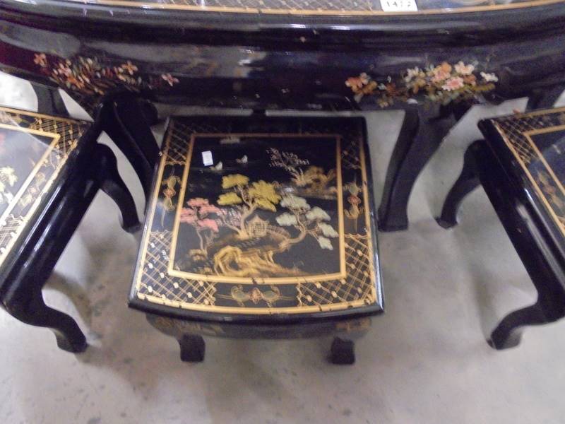 A large oval black lacquered coffee table with six small nesting tables, COLLECT ONLY. - Image 3 of 4