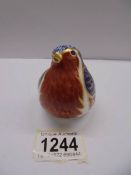 A Royal Crown Derby robin paperweight with gold stopper.
