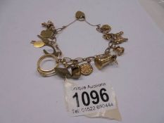 A 9ct gold bracelet with forteen charms, 25.3 grams.