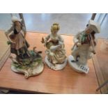 A Capo di monte girl with chicken (a/f), a Staffordshire figure of a fiddler and one other figure.