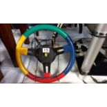 A Renault multi coloured steering wheel Diameter 33cm approximately