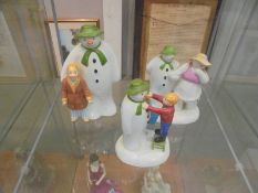 Three Coalport 'The Snowman' figures including money box, adding a smile etc.,