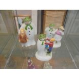 Three Coalport 'The Snowman' figures including money box, adding a smile etc.,