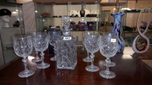A heavy cut glass decanter and 8 glasses