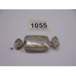 A silver pill box in the shape of a wrapped sweet, 13 grams.