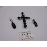 A Whitby? jet cross brooch (pin a/f) and a pair of Whitby? jet earrings.