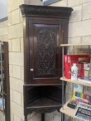 A Georgian oak corner cupboard with carved door (COLLECT ONLY)
