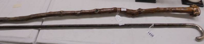 A silver handled walking cane and an unusual walking with multi head top box (possibly for snuff).