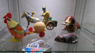 A quantity of tin plate and plastic clockwork toys inc. 1960's Russian clown with horse & carriage.
