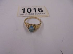 A yellow gold topaz and zircon ring, size L, 2 grams.