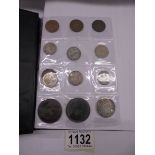 A folder of assorted coins including pre 1947 silver, half crowns etc.,
