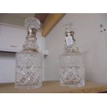 A pair of superb quality heavy cut glass decanters with silver collars and silver labels.