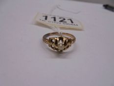 A unmarked ring set seed pearl (tests as 9ct) size L, 2.3 grams.