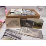 A large box of assorted postcards.