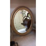 An oval gilt framed bevel edged mirror. approximately 50cm x 60cm. COLLECT ONLY
