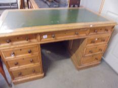 A double pedestal partners desk with green leather inset top. COLLECT ONLY.