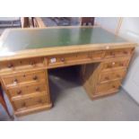 A double pedestal partners desk with green leather inset top. COLLECT ONLY.