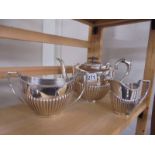 A three piece silver plate tea set.