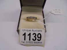 A diamond and tanzanite ring, 4 tansanites, 6 diamonds dated Birmingham 2005,18ct gold. Size K half.
