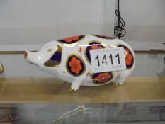 A Royal Crown Derby pig paperweight.