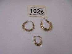 Three gold earrings, 1.7 grams.