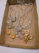 A crystal necklace, bracelet, brooch and a quantity of earrings.