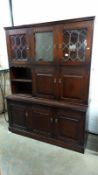 A dark oak wall unit with leaded glass doors, COLLECT ONLY