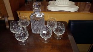 A heavy cut glass decanter and 6 glasses