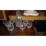 A heavy cut glass decanter and 6 glasses