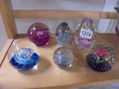 Six glass paperweights.