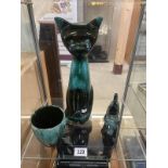 A green glazed terracotta tall cat cow creamer and a mug