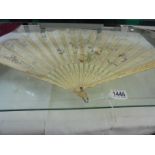 An antique hand decorated fan with lace edge.