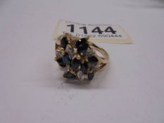 A diamond sapphire cluster ring, 11 marquise cut sapphires and 8 diamonds in a 9ct gold setting