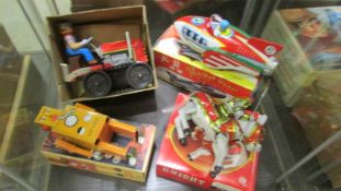 Four boxed tin plate clockwork toys including Robot, Knight, Rocket racer and bulldozer.