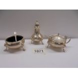A Three piece silver condiment set with blue glass liners (silver weight 236 grams).
