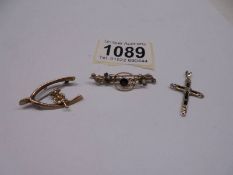 A gold garnet and seed pearl brooch, a Lincoln Imp brooch and an a/f gold cross, 4 grams.