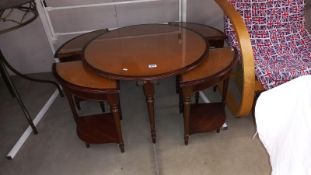 A good round nest of tables with gilded leather tops under glass, COLLECT ONLY