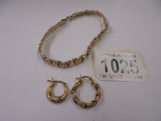 A silver gilt bracelet and two silver gilt earrings.