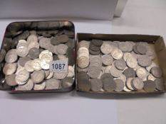 A tin box and a tray of 10p and 2/- coins.