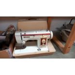 A cased New Home sewing machine. COLLECT ONLY