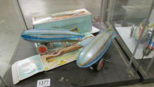 Two boxed tin plate clockwork Zeppelins, (one box a/f).