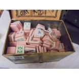 A vintage Mahjong set in a tin box.