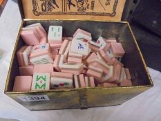 A vintage Mahjong set in a tin box.