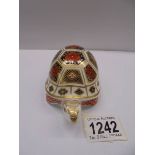 A Royal Crown Derby tortoise paperweight with silver stopper.