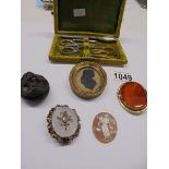 A mixed lot including silhouette brooch, cameo brooch part manicure set etc.,