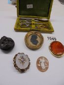 A mixed lot including silhouette brooch, cameo brooch part manicure set etc.,
