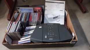 A Bose wave radio/cd with remote (remote in office) and quantity of cd's, cassettes etc